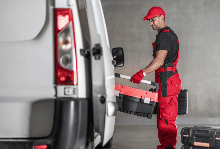 Man loading tools into van