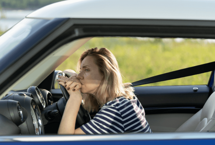 Anxious female driver at wheel of car