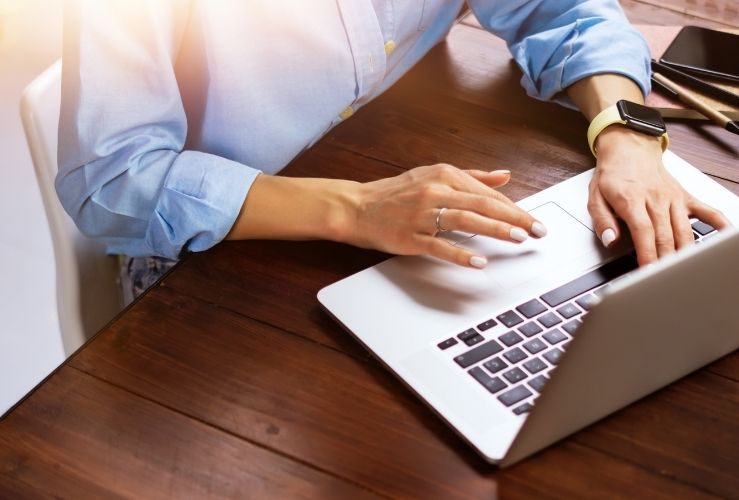 Image of woman using laptop to renew driving licence