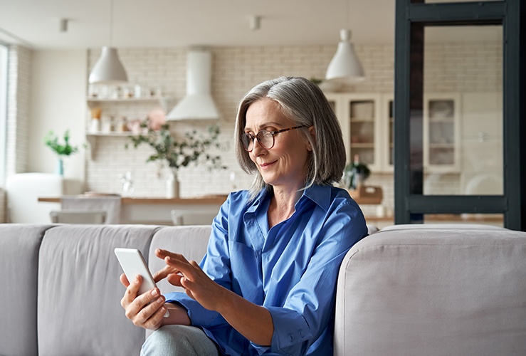 older middle aged customer holding smartphone