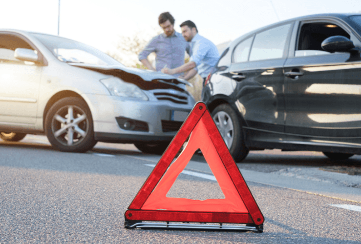 Men exchanging insurance details after car accident