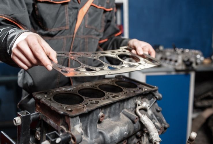 Mechanic holding head gasket car part