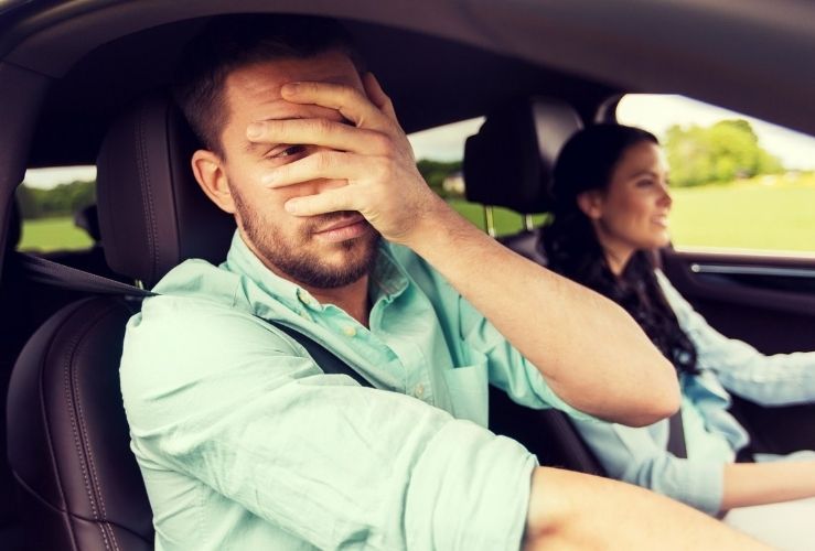 Man cringing at poor driving