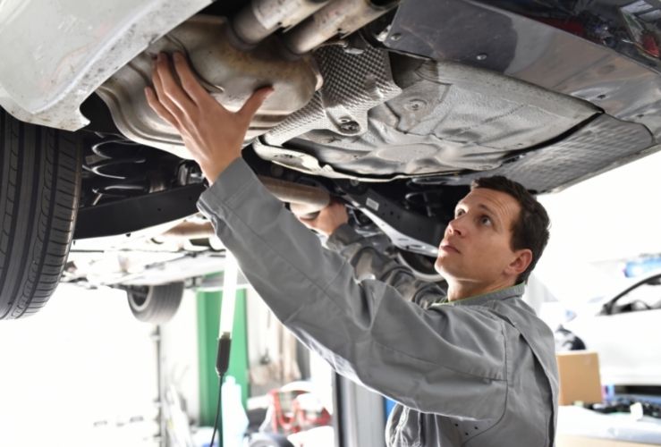 Mechanic working on car in garage