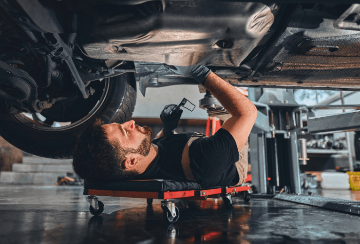 Mechanic working underneath car