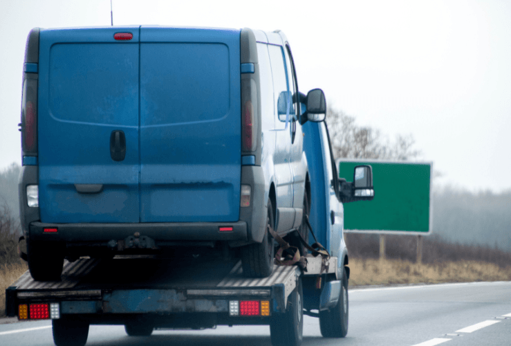 Broken down van on recovery truck