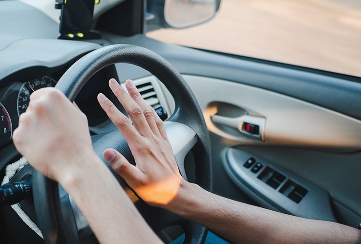 Driver pressing on their horn