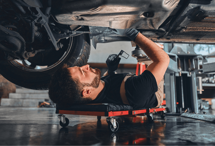 Mechanic working underneath car