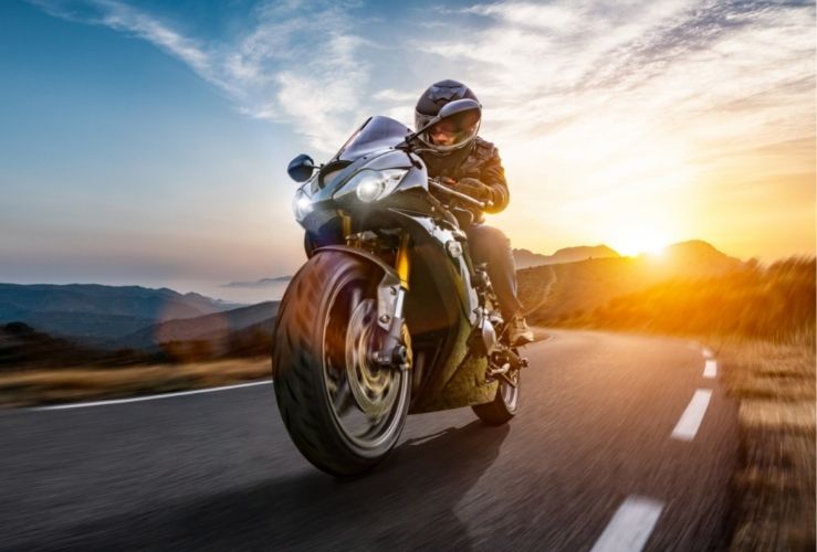 Motorbike being ridden on open coastal road