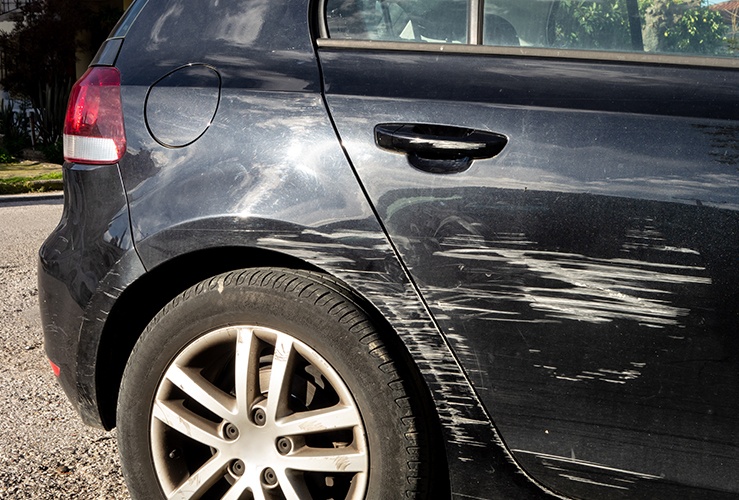 Black car with scratched panel 