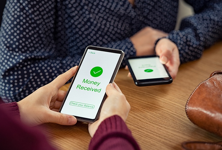 Woman receiving digital money using phone