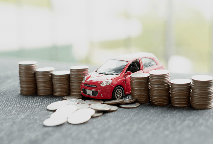 Pile of coins surrounding a toy car