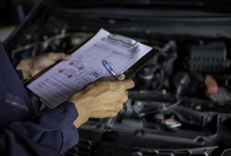 Mechanic holding MOT paperwork