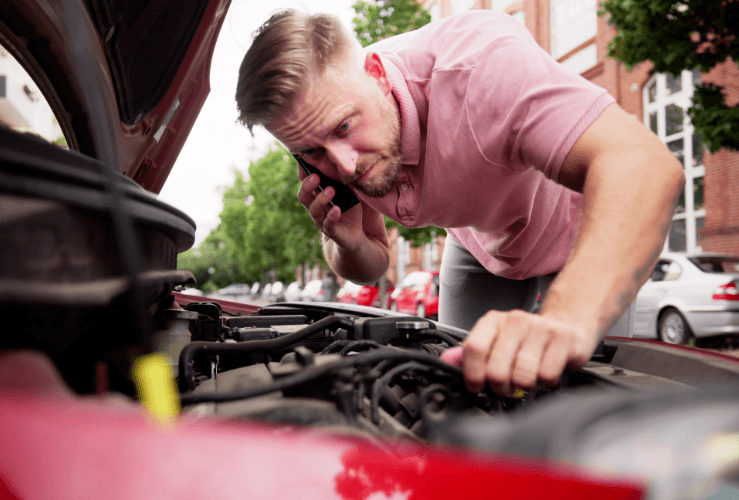 Man on phone to car breakdown provider