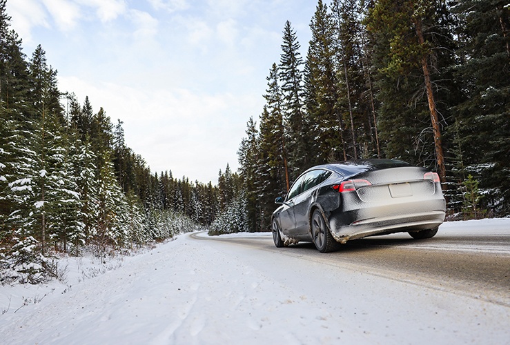 Electric vehicle driving in snowy setting