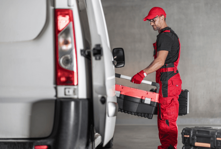 Man loading tools into van