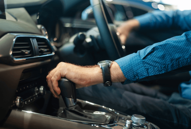 Man changing gear in car