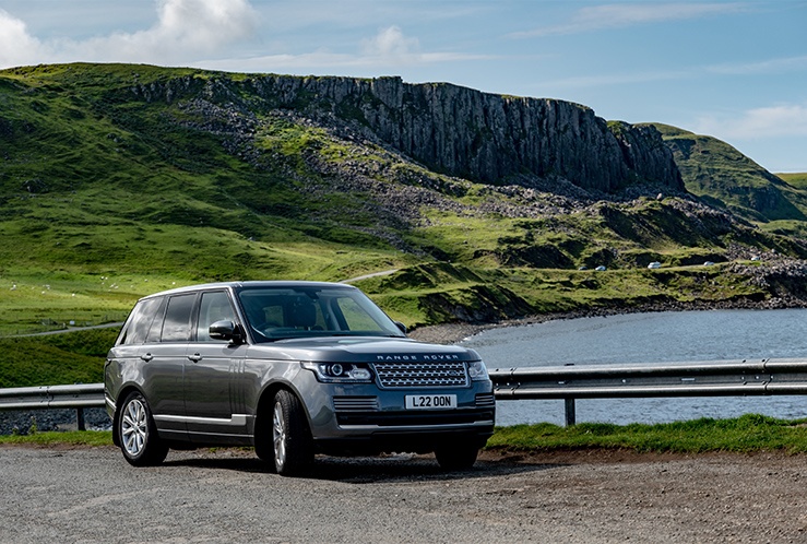 Picture of a grey car next to a body of water